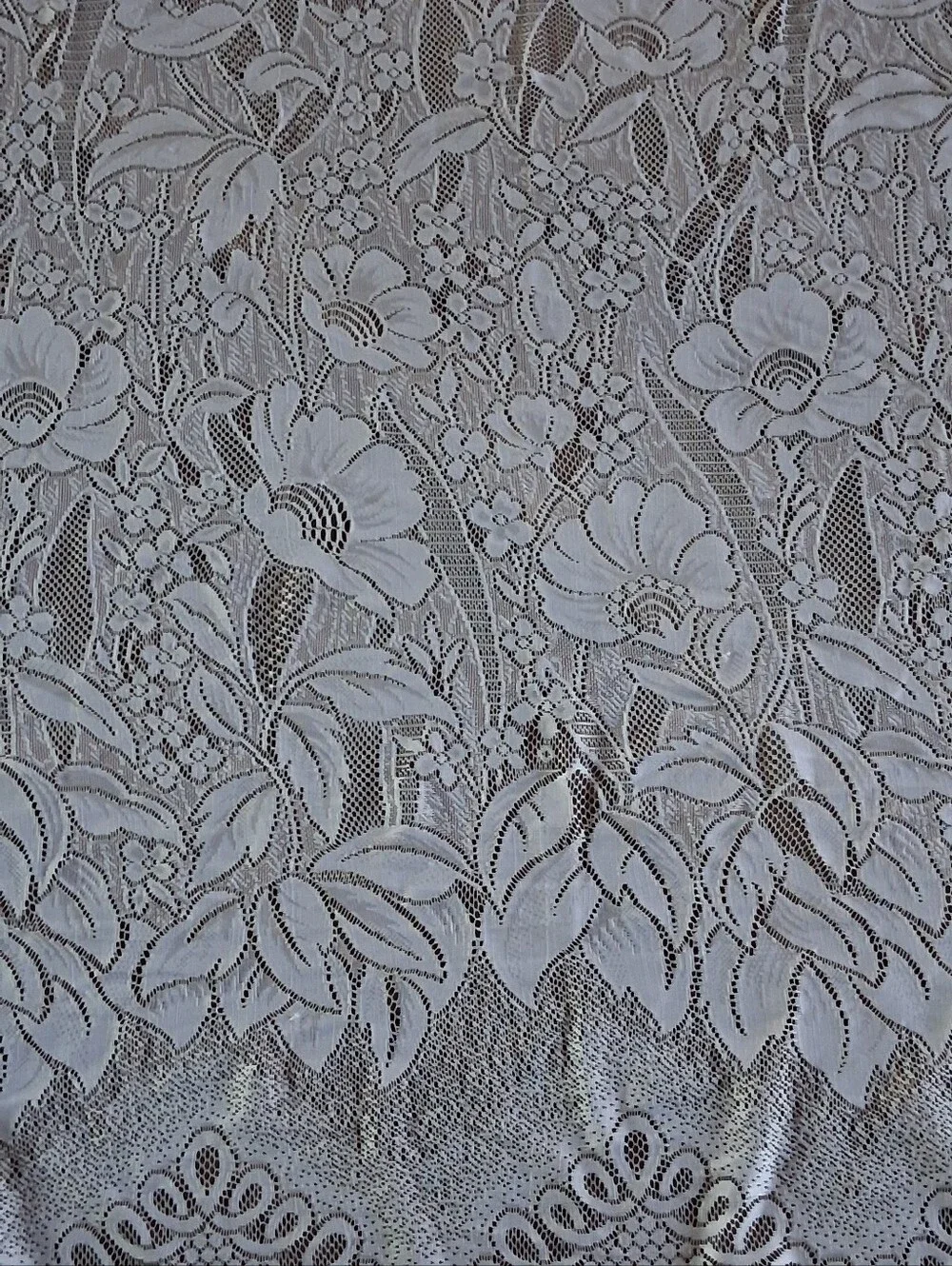 Vintage style floral lace curtain panel featuring an attached scalloped valance.